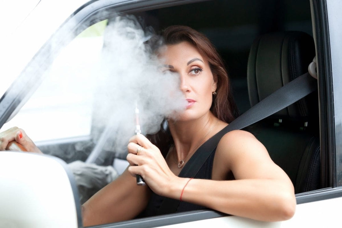 Woman vaping in a car, smoke visible.