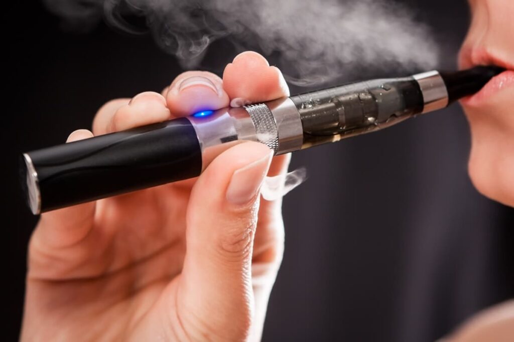 Person vaping with an electronic cigarette.