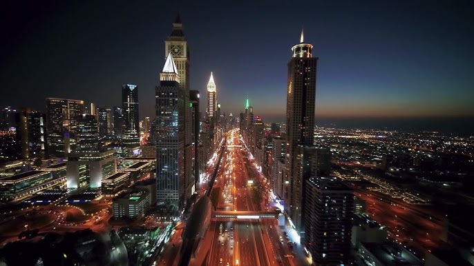 City skyline with illuminated buildings at night.